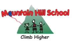 A mountain hill school logo with three children on top of the hill.