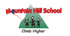 A mountain hill school logo with three people climbing up the side of a mountain.