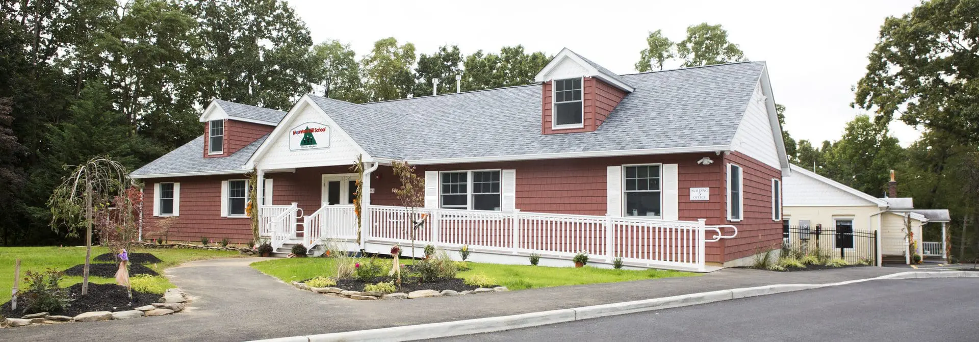 A red and white house with a picket fence.